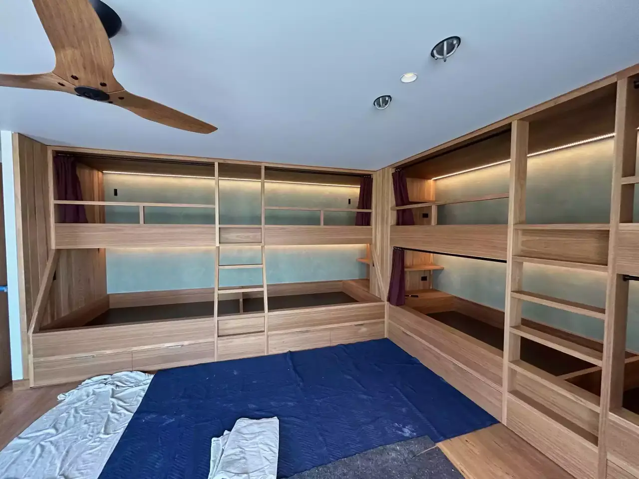 Bunk room joinery from the doorway, with the ceiling fan above